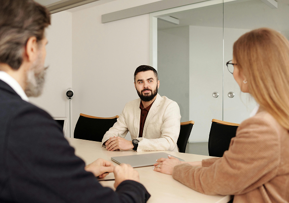 Three persons in a meeting room