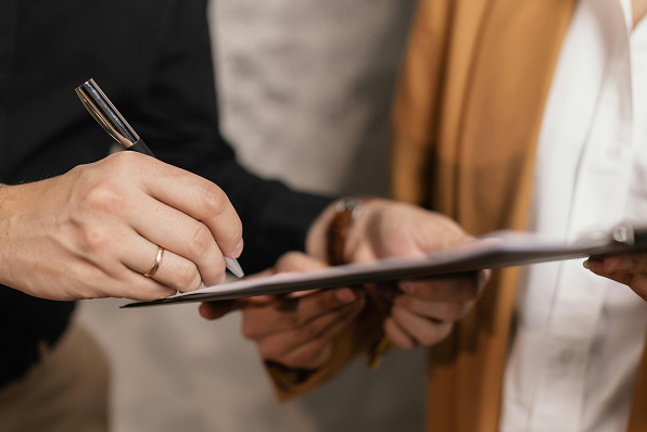 A man signing a document.
