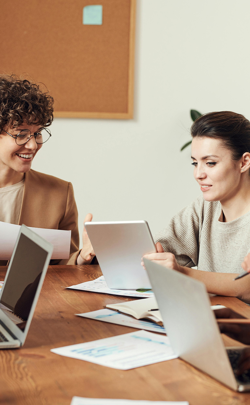 Two women in a meeting with computers